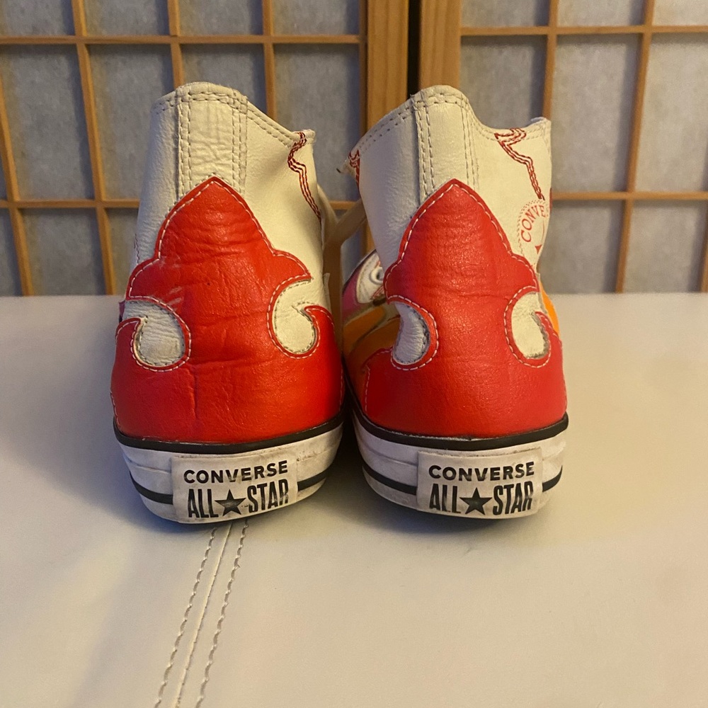 Multi-colored. high top converse. Size 7.5
